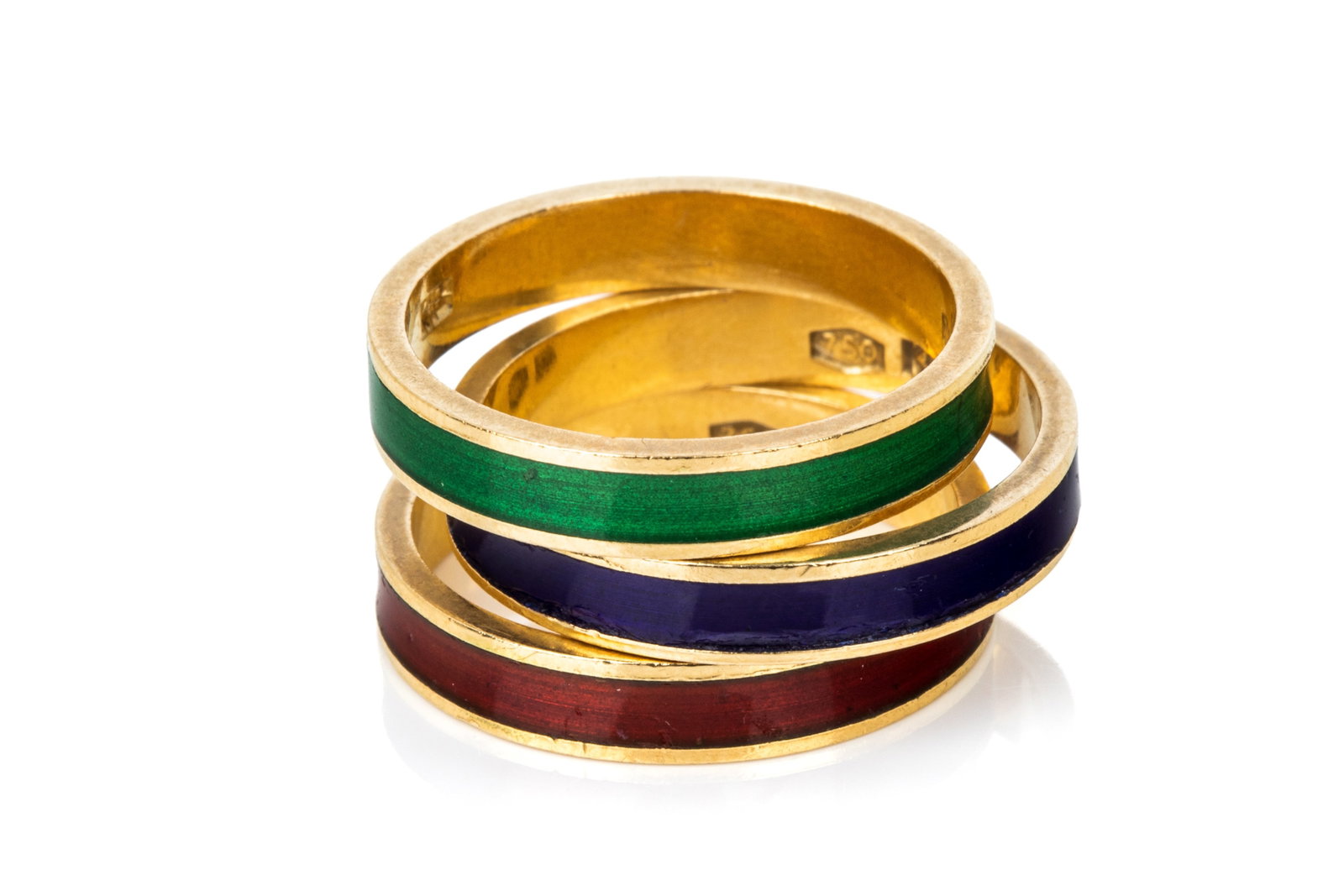 TRIO OF 18K GOLD & ENAMEL STACKING BANDS 8.5g: 3 matched 18K yellow gold stacking bands measuring 3.6mm wide by 1.3mm thick. Featuring red, blue, and orangeish red enamel. Size: 6.75 (blue) 6.25 (red & green) 8.5 grams together