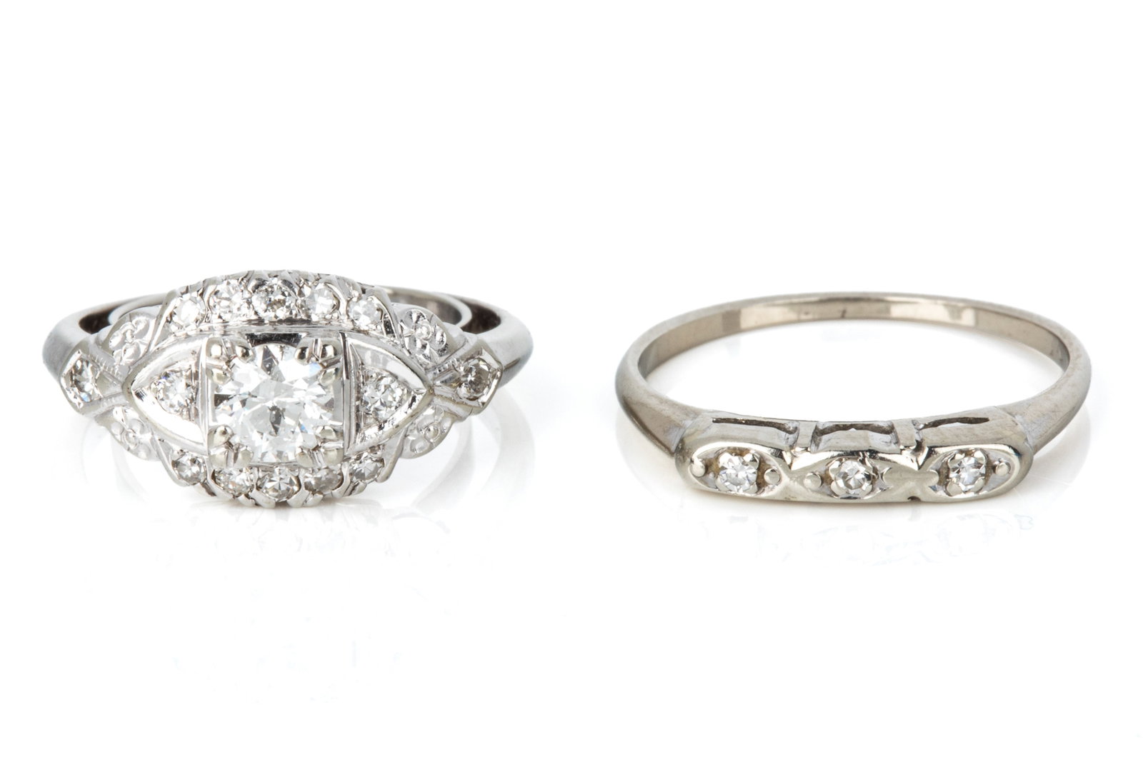 TWO 14K WHITE GOLD DIAMOND RINGS 5.1g: 14K white gold diamond ring measuring 9.2mm wide by 5.2mm tall. Featuring 1 round brilliant cut diamond weighing approximately 0.36ct of I1-HI quality. Accented by 14 round single cut diamonds.