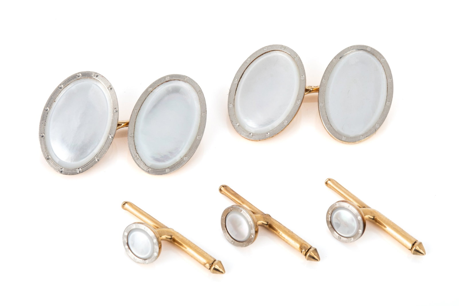 14K GOLD & MOTHER OF PEARL TUXEDO SET 11.1g: 14K yellow and white gold mother of pearl tuxedo set featuring French-cuff cufflinks measuring 17.9mm x 12.6mm. Spring loaded buttons measuring 7mm in diameter. 11.1 grams