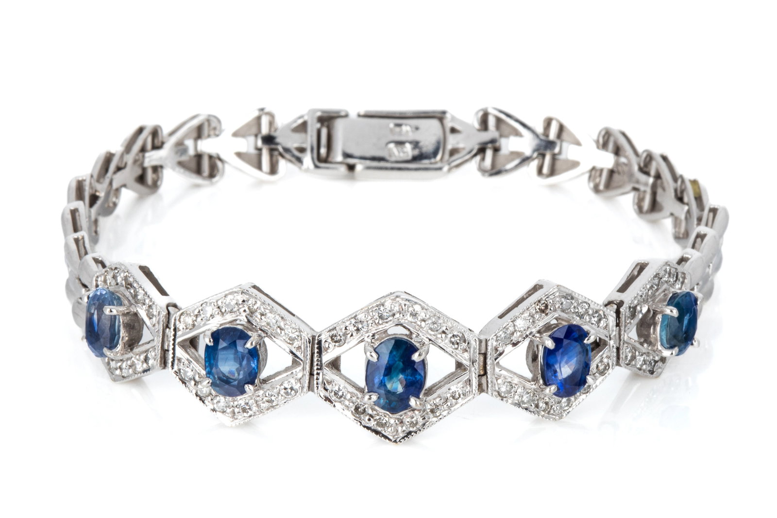 10K WHITE GOLD SAPPHIRE & DIAMOND BRACELET 18.8g: White gold bracelet testing approximately 10K, measuring 6.5 to 6.75 inches wearable length by 12.9mm wide. Equipped with heavy ladder clasp. Featuring 5 oval mixed cut natural medium blue sapphires,