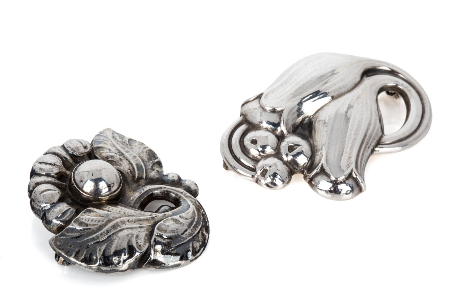 GEORG JENSEN FLORAL BROOCHES, 100B & 71: Vintage Georg Jensen sterling silver Tulip brooch, model 100B, post-1945 hallmarks, with round hinge and roll lock. Measuring 43.4mm by 31.1mm. 8.9 grams Vintage Georg Jensen sterling silver Floral br