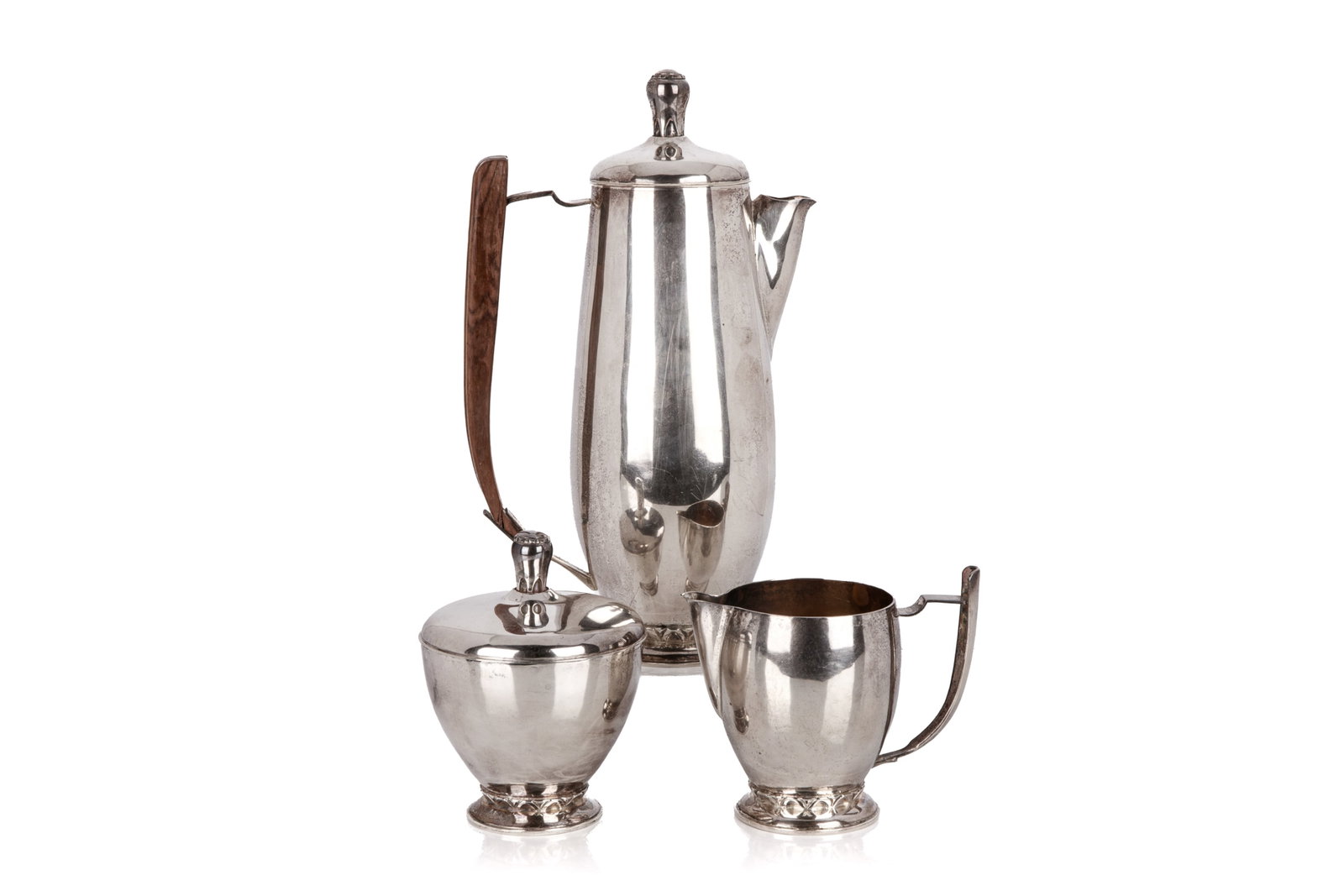 CANADIAN SILVER COFFEE SET 1364g: A Canadian three piece sterling silver coffee set by silversmith Jack Sullivan. Scratch dated and signed, 1950 the set is in a Scandinavian style. Both the cream and sugar have gilded interiors. The p