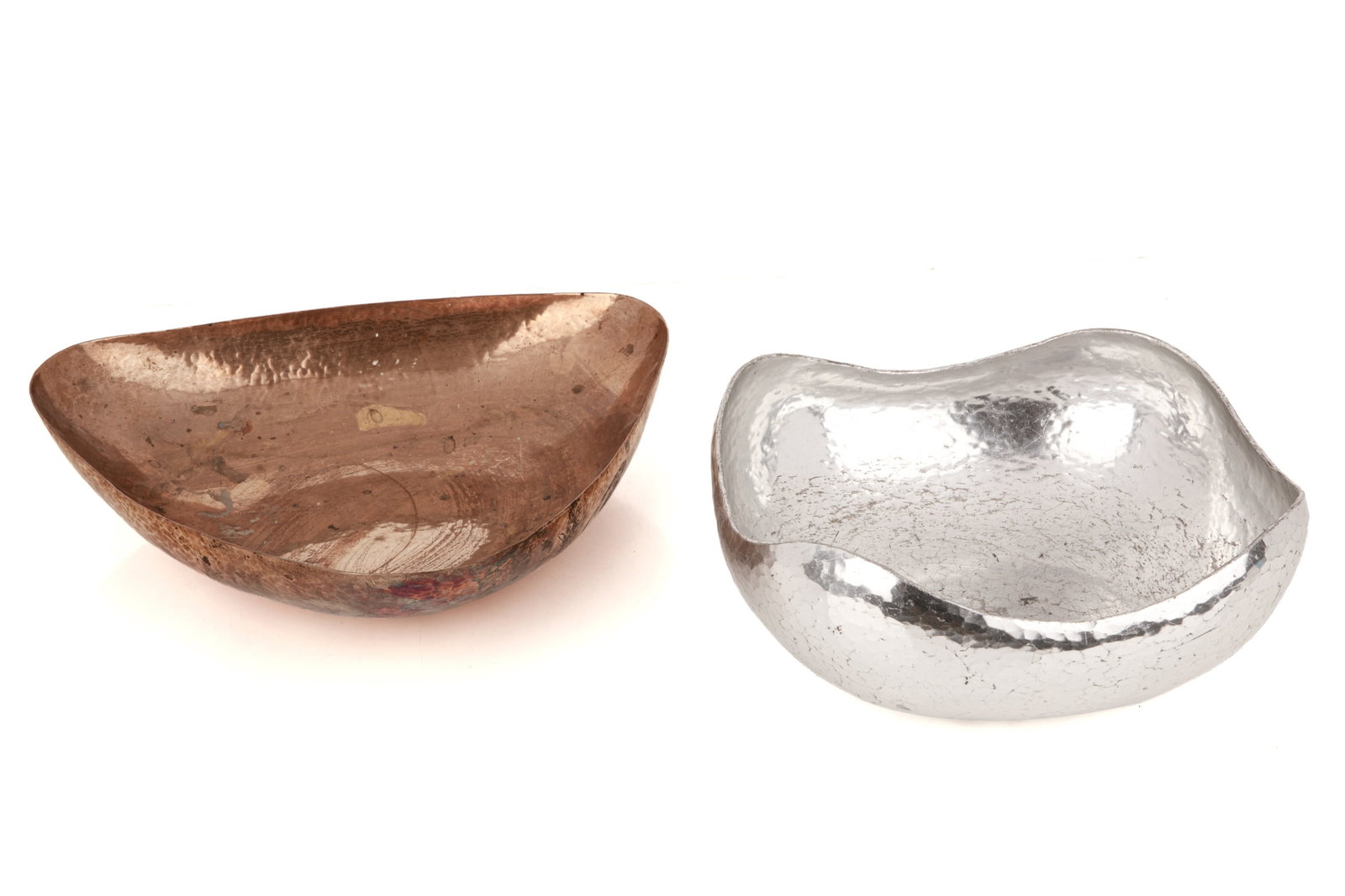 TWO HAMMERED FUSSELL BOWLS: Two hammered bowls from the workshop of Andrew Fussell . The first is triangular and made of copper, dated 1964. The second is square and made of aluminum, dated 1968. Size of square bowl. 8.5 in 21 c