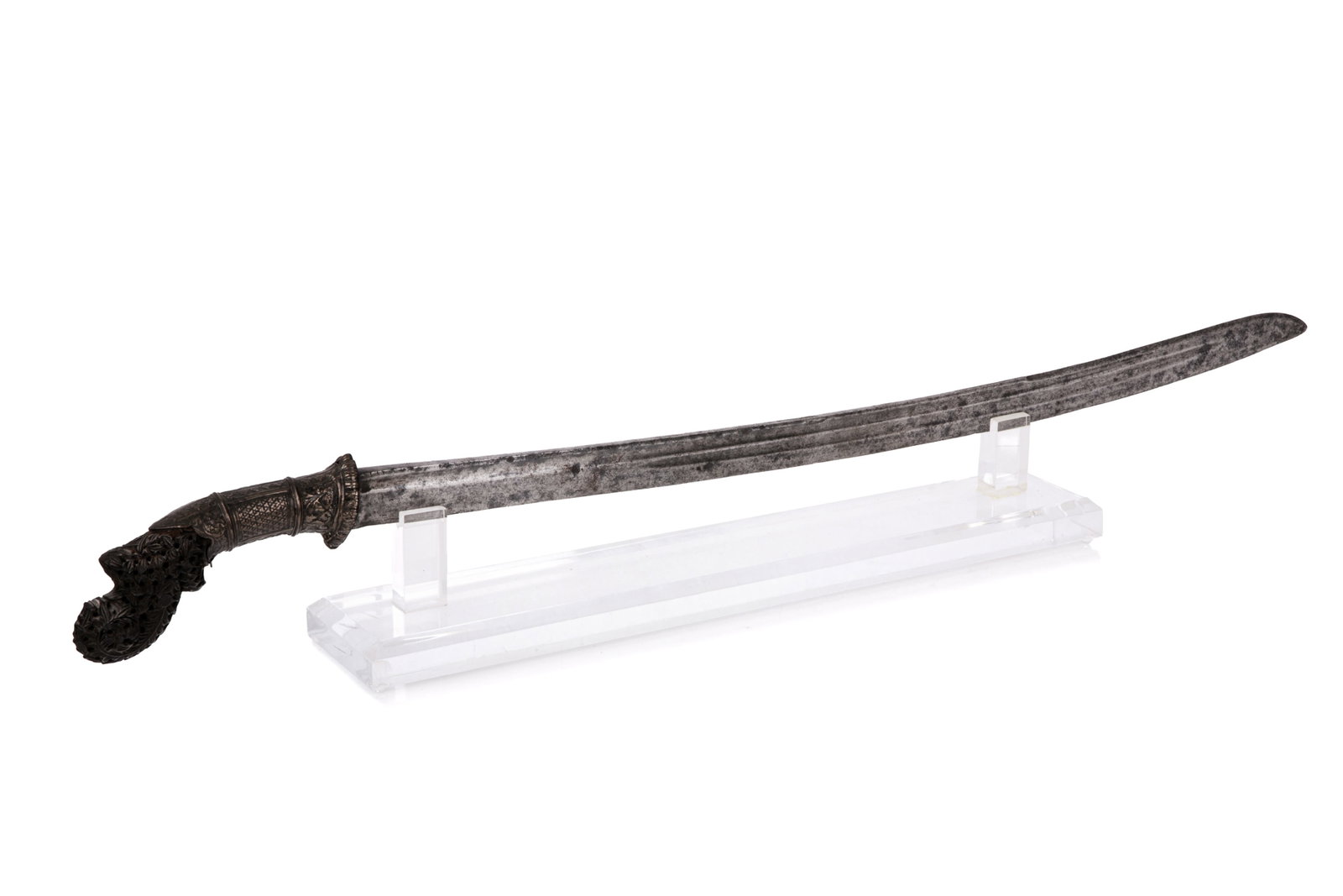 INDONESIAN PEDANG SWORD: Featuring a finely carved hilt with repousse silver mountings. L. 32 1/2in (82.4cm)