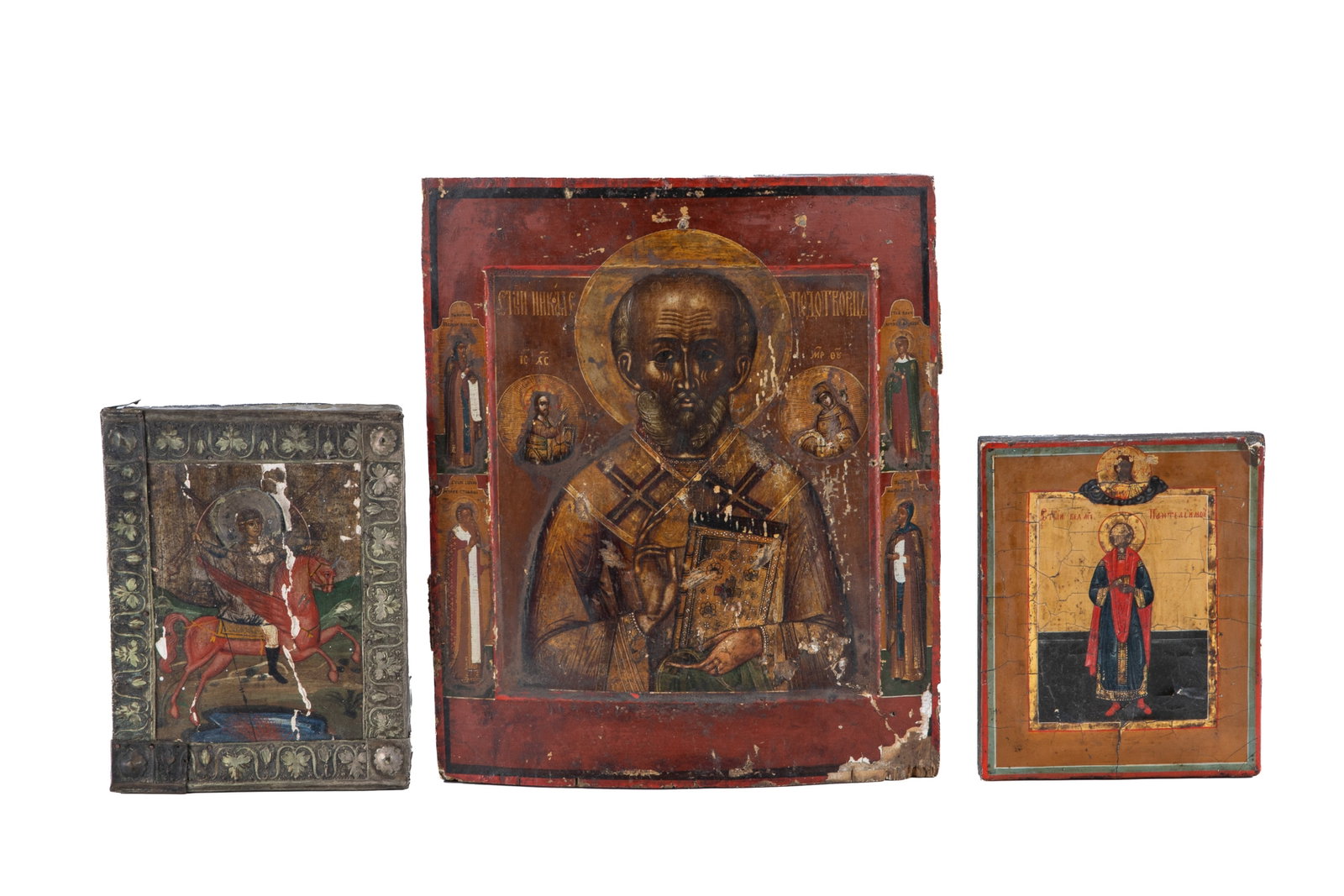 GROUP OF THREE ANTIQUE EASTERN ORTHODOX ICONS: Three antique Eastern Orthodox icons painted on wood depicting saints and an "angel on a red horse" (Zechariah 1:8). Largest measures H. 12 3/8" x W. 10 1/2".