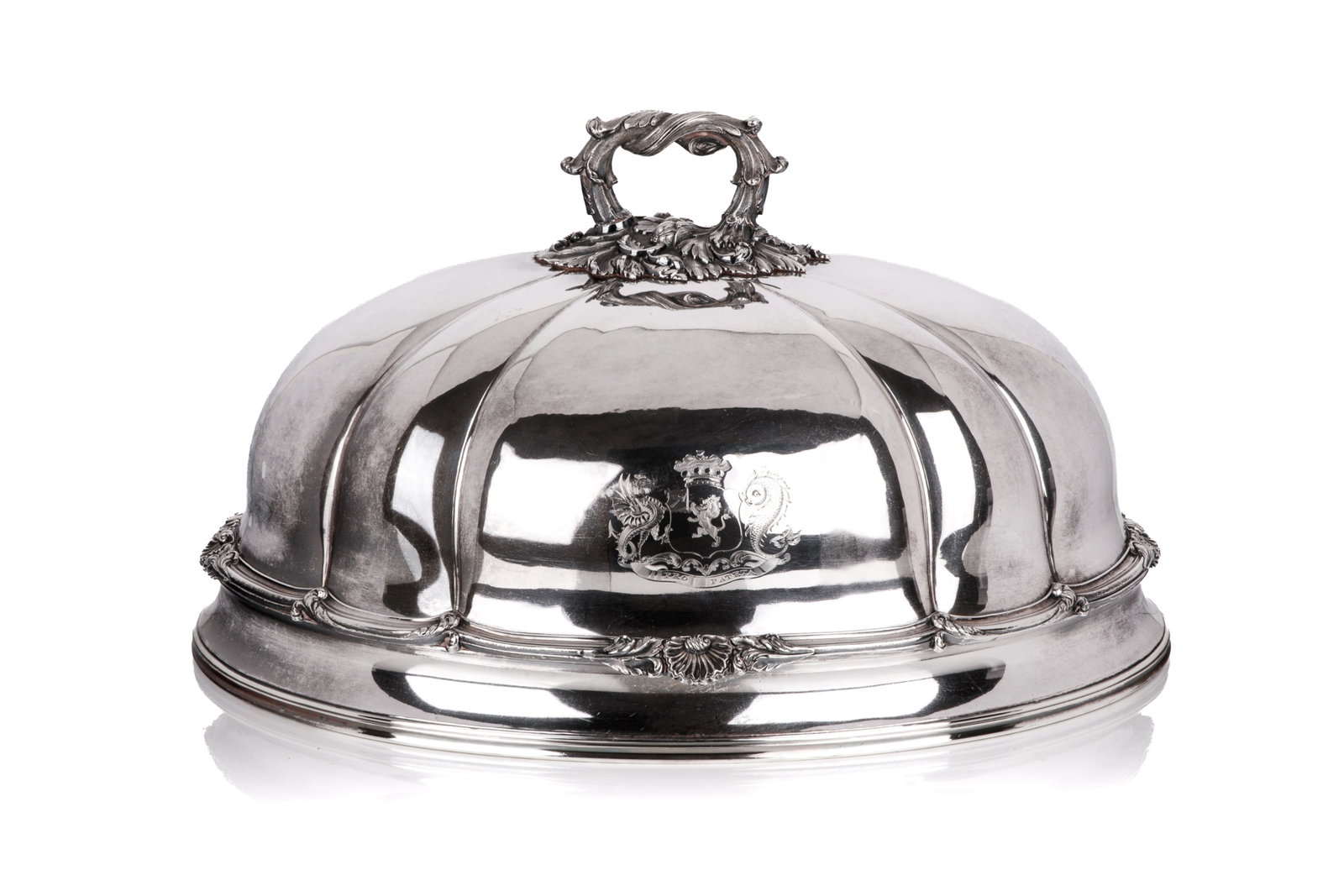 SHEFFIELD PLATE MEAT DOME: An English silver-plated fluted oval meat dome cover, fitted with a cast foliate handle, and an engraved coat of arms with motto 'PRO PATRIA'. H. 10 1/2in x L. 18 7/8in x W. 14 1/8in (26.7cm x 48cm x