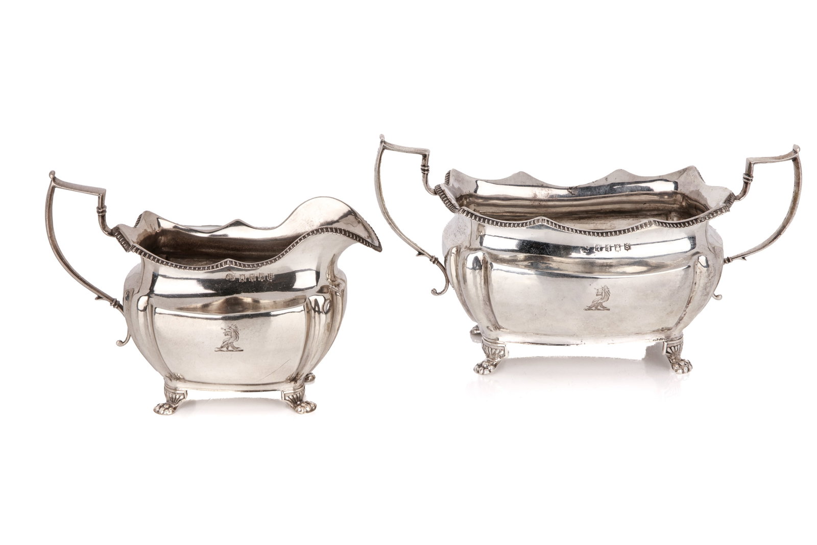 GEORGE III IRISH SILVER CREAM & SUGAR, 449g: Squared form with egg and dart border, crested. Maker Richard Sawyer, Dublin,1814. Sugar H. 4 3/4in x W. 8 5/8in x D. 4 1/4in (12.2cm x 22.1cm x 10.6cm) 449g