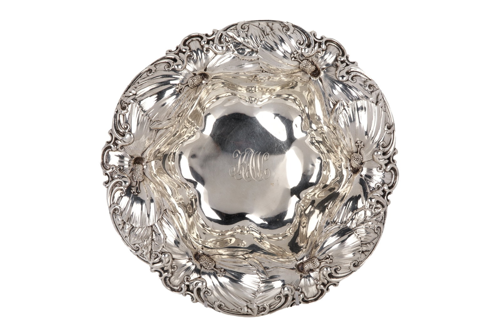 STERLING SILVER BOWL BY WHITING, 645g: A sterling silver bowl by Whiting Manufacturing Company, New York. Featuring a lobed rim decorated with embossed scrolls and overlapping blooms. Stamped to the underside with the Whiting maker's mark,