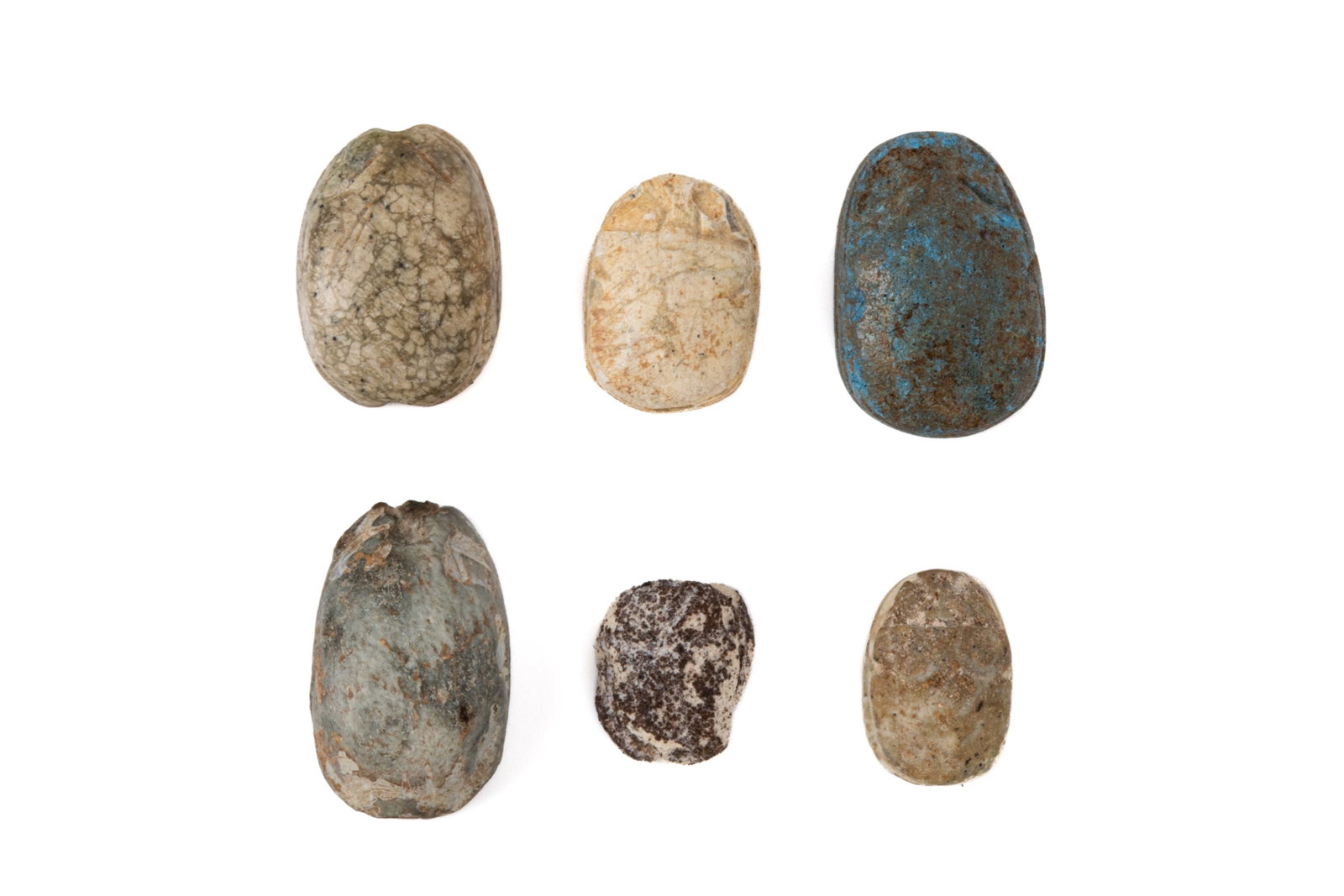SIX ANCIENT STEATITE SCARABS OF PROTECTIVE SEALS: One scarab featuring a "meander" motif of spiralling, labyrinthine lines. Another scarab featuring a twisting rope motif, likely meant to represent eternity (The "Nile Loop") or the infinite cycles of