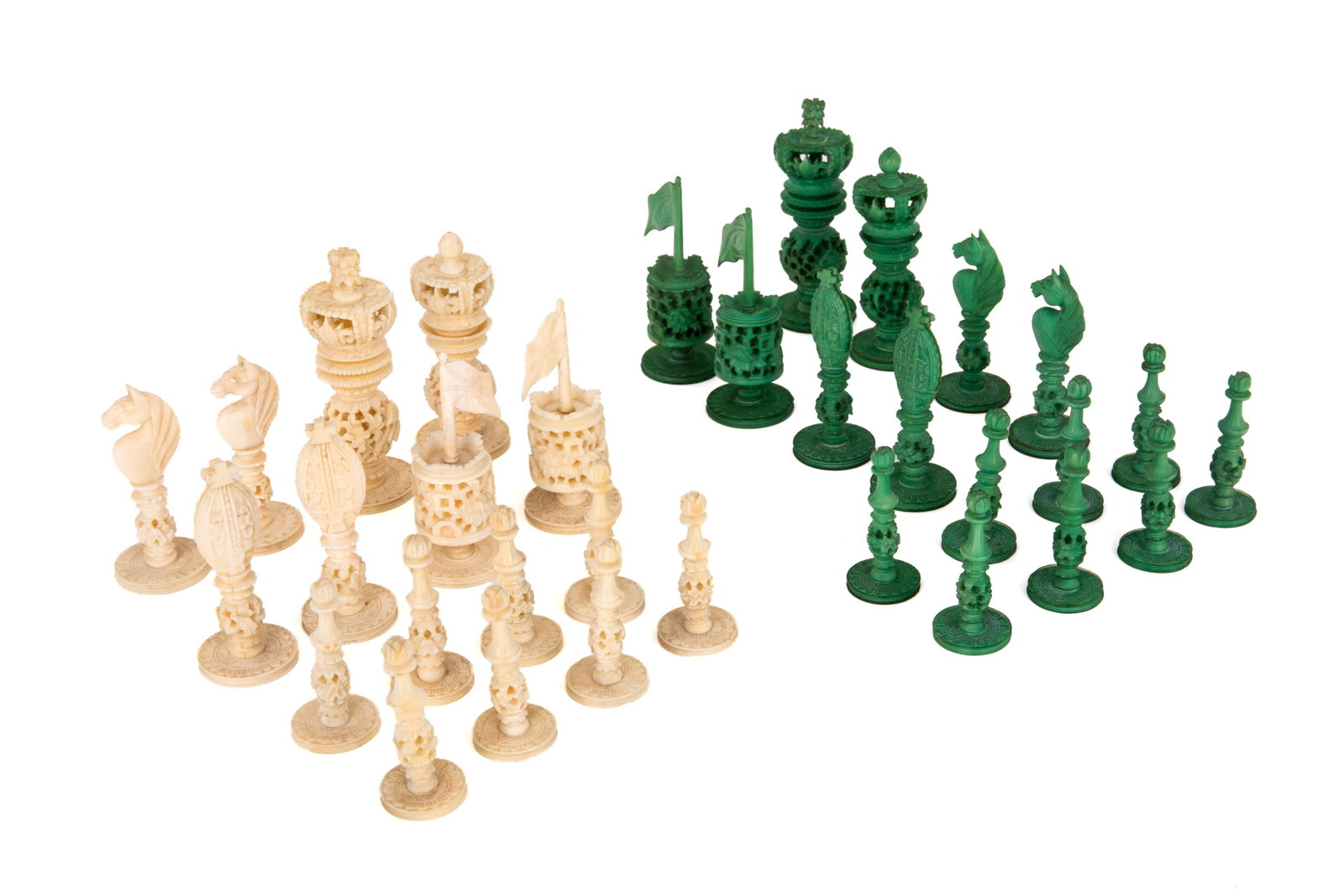 32pcs, CHINESE EXPORT NATURAL CARVED CHESS SET: Late 19th/early 20th century. Comprising a complete 32-piece set of natural and green-stained natural carved chess pieces. H. 3 1/8 in (8cm)