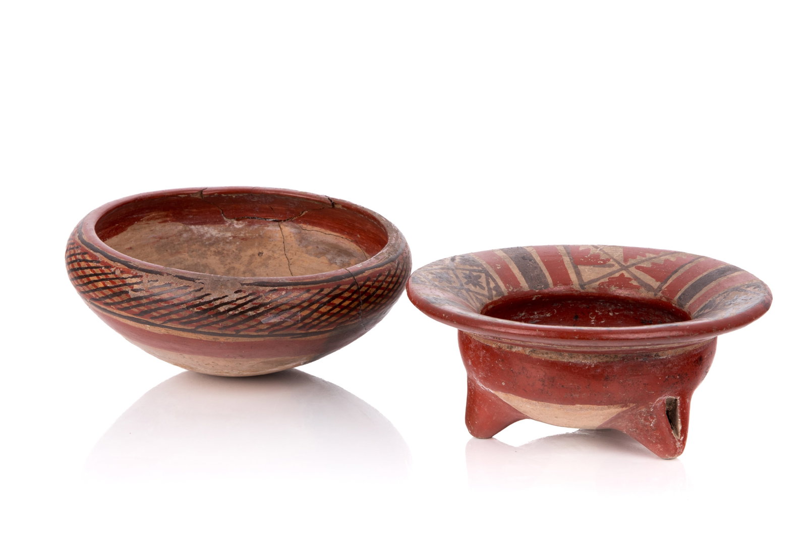 TWO PRE-COLUMBIAN EARTHENWARE POTTERY BOWLS: One tumbler bowl and another with three feet. Both are polychromed, painted with red ochre and geometric designs along the rim of the three-footed bowl and the body of the tumbler bowl. Likely from