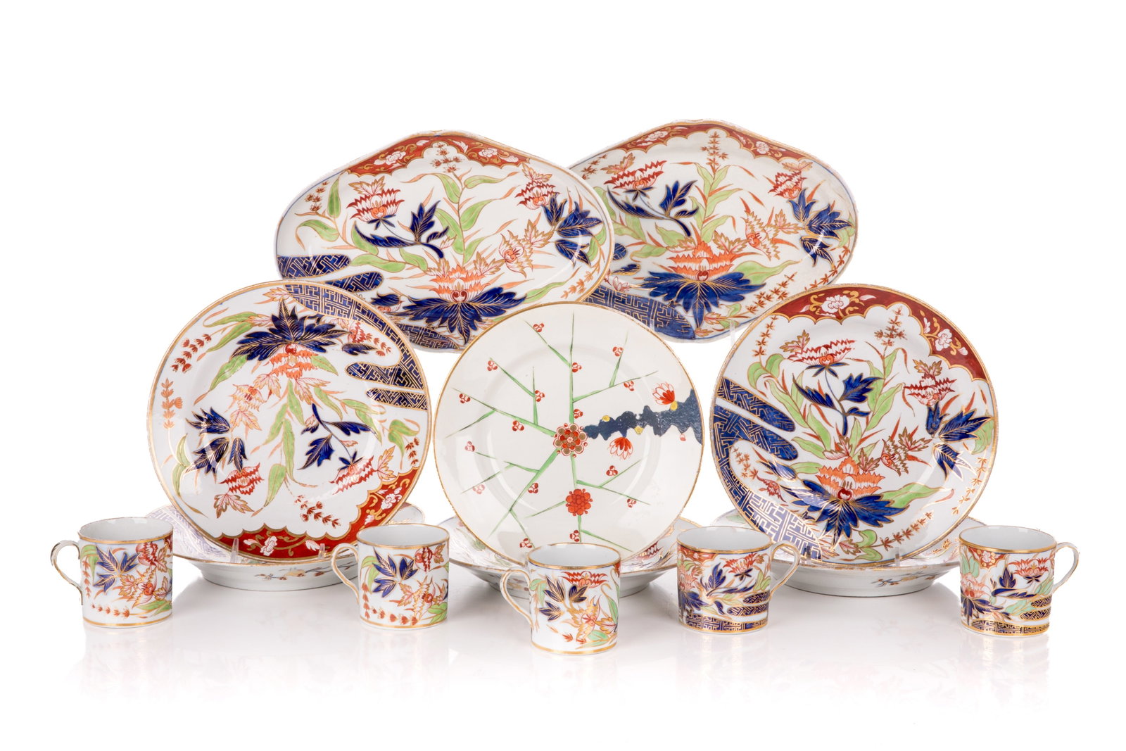 19th C ENGLISH IMARI PORCELAIN PIECES: Includes 5 plates, 5 demi-tasse cups, and 2 small trays in the Imari colouring of coral, cobalt blue, gilding, and green. With floral motifs and geometric interludes. Along with the set is a Derby