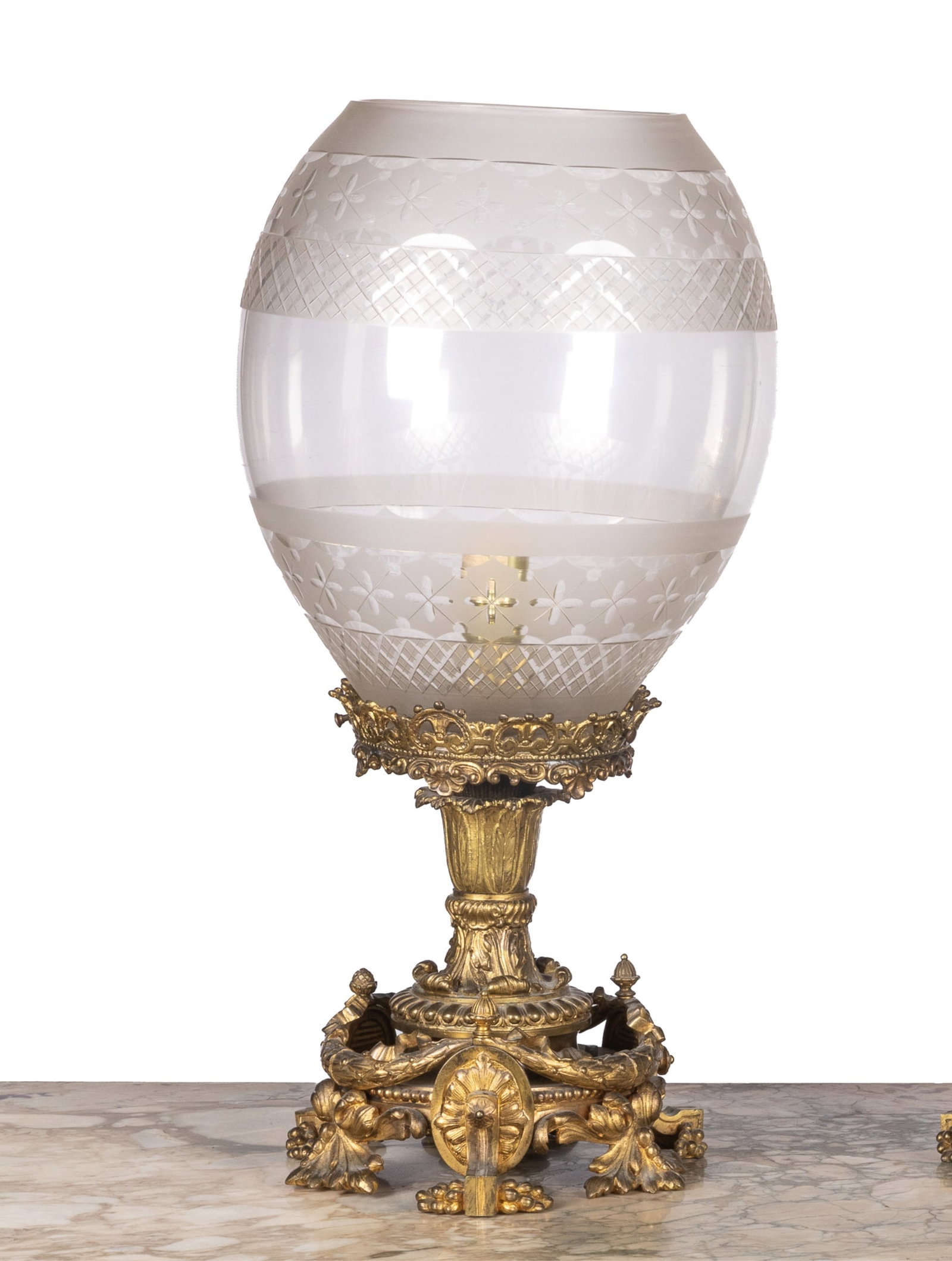 PAIR OF NEOCLASSICAL STYLE HURRICANE LAMPS: Frosted glass shade featuring etched motifs, raised on gilt metal base. One shade only. Overall H. 20in (50.8cm)