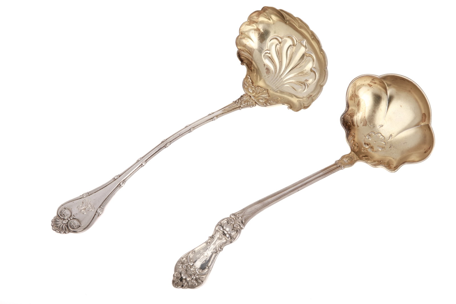 TWO AMERICAN GILDED SILVER LADLES, 219g: Includes two American sterling silver ladles with gilt bowls. One in the "New Empire" pattern, maker's mark for Whiting Manufacturing Co., pat. for retailer J.B. Chambers & Co.; one in the "Daffodil"