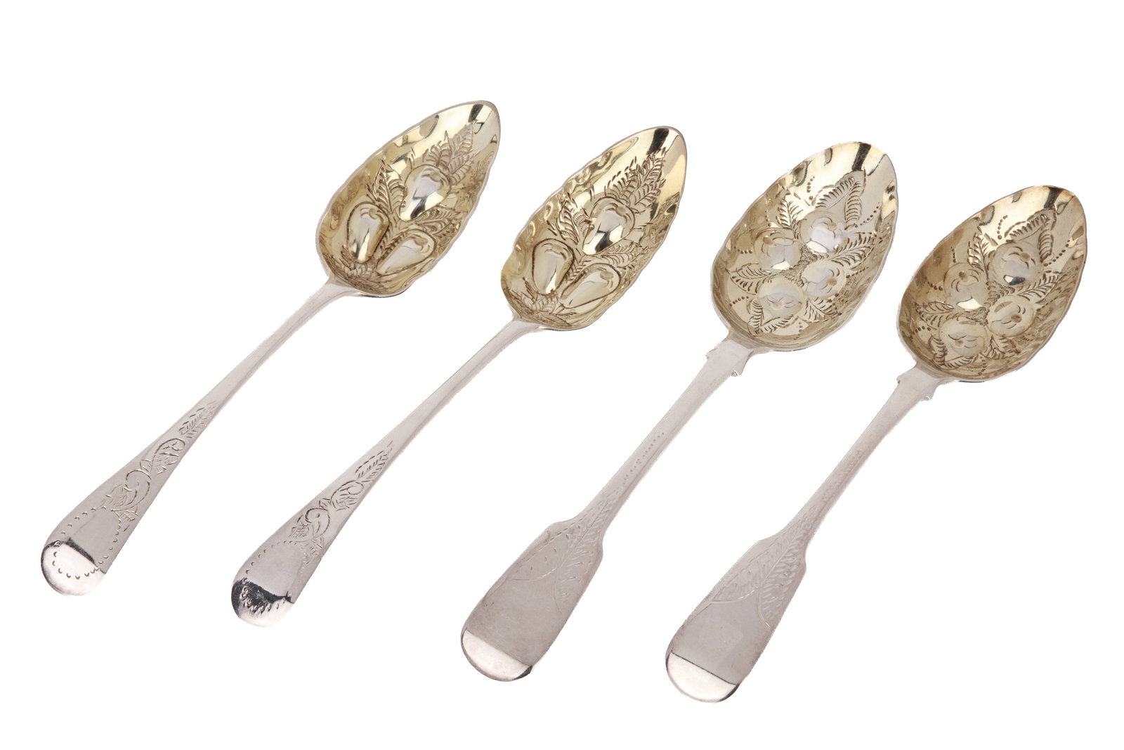 TWO PAIR OF GEORGIAN SILVER BERRY SPOONS, 308g: Early 19th century. The assembled set of 4 parcel-gilt spoons comprising two pairs, each featuring repouss? fruit and foliage. Various date marks and makers' marks. Overall weight 308grams L. 9 1/4in