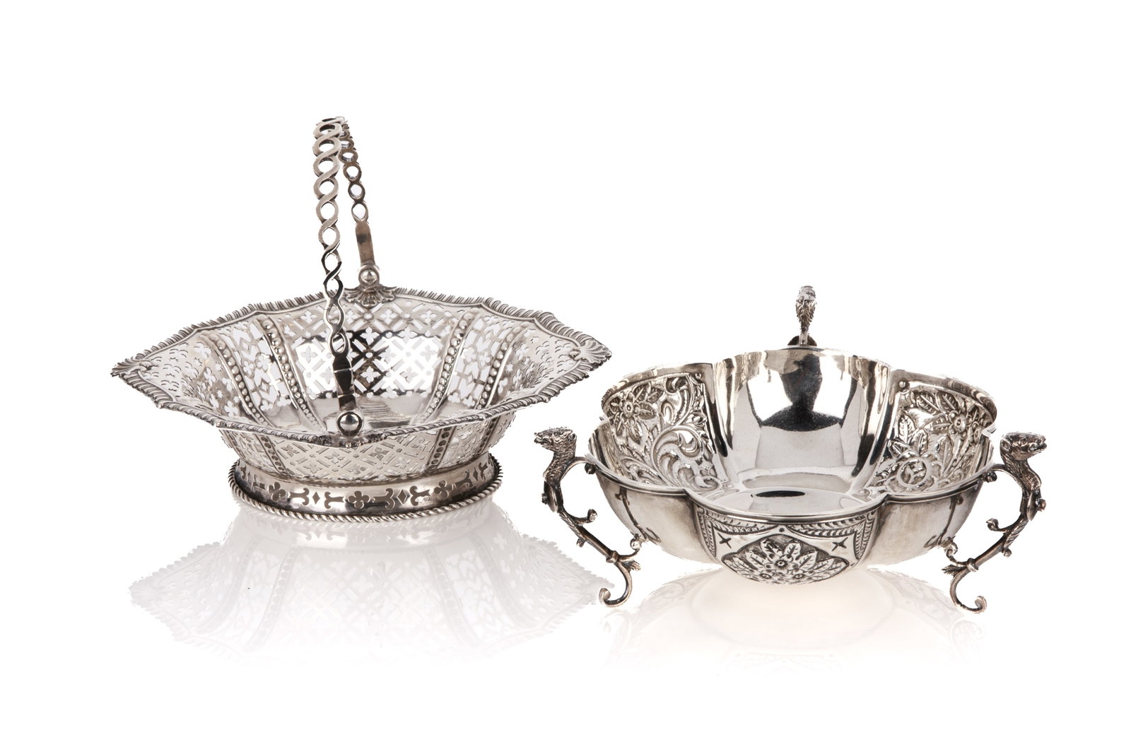 ENGLISH SILVER BOWL AND HANDLED BASKED, 245g: Two silver decorative tableware pieces. The first is a lobed footed bowl featuring chased floral panels, supported by three legs with hound-head terminals. The second is an elegant sweetmeat basket