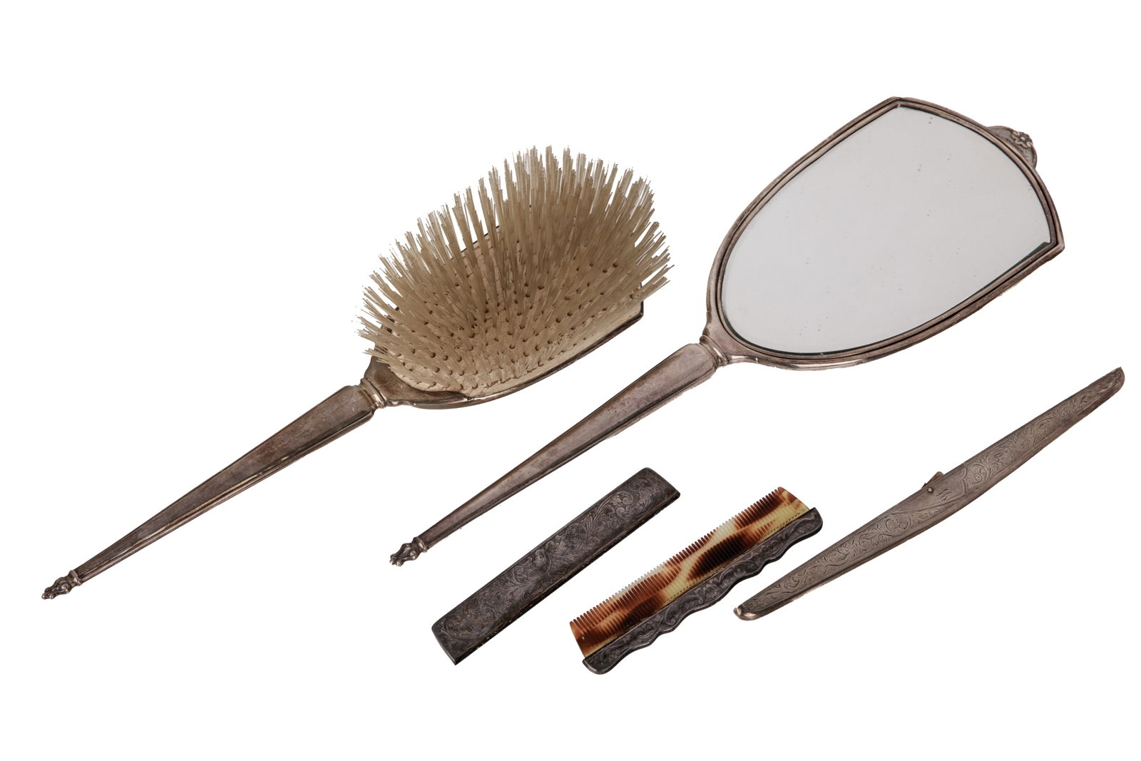 4 pc. SILVER VANITY SET, 198g: Silver vanity set featuring an intricate, matching floral repousse and scroll motif. Includes 1 comb; 1 large hand mirror (excluded from weight); 1 comb sleeve case; 1 case. Weight 198 grams Mirror