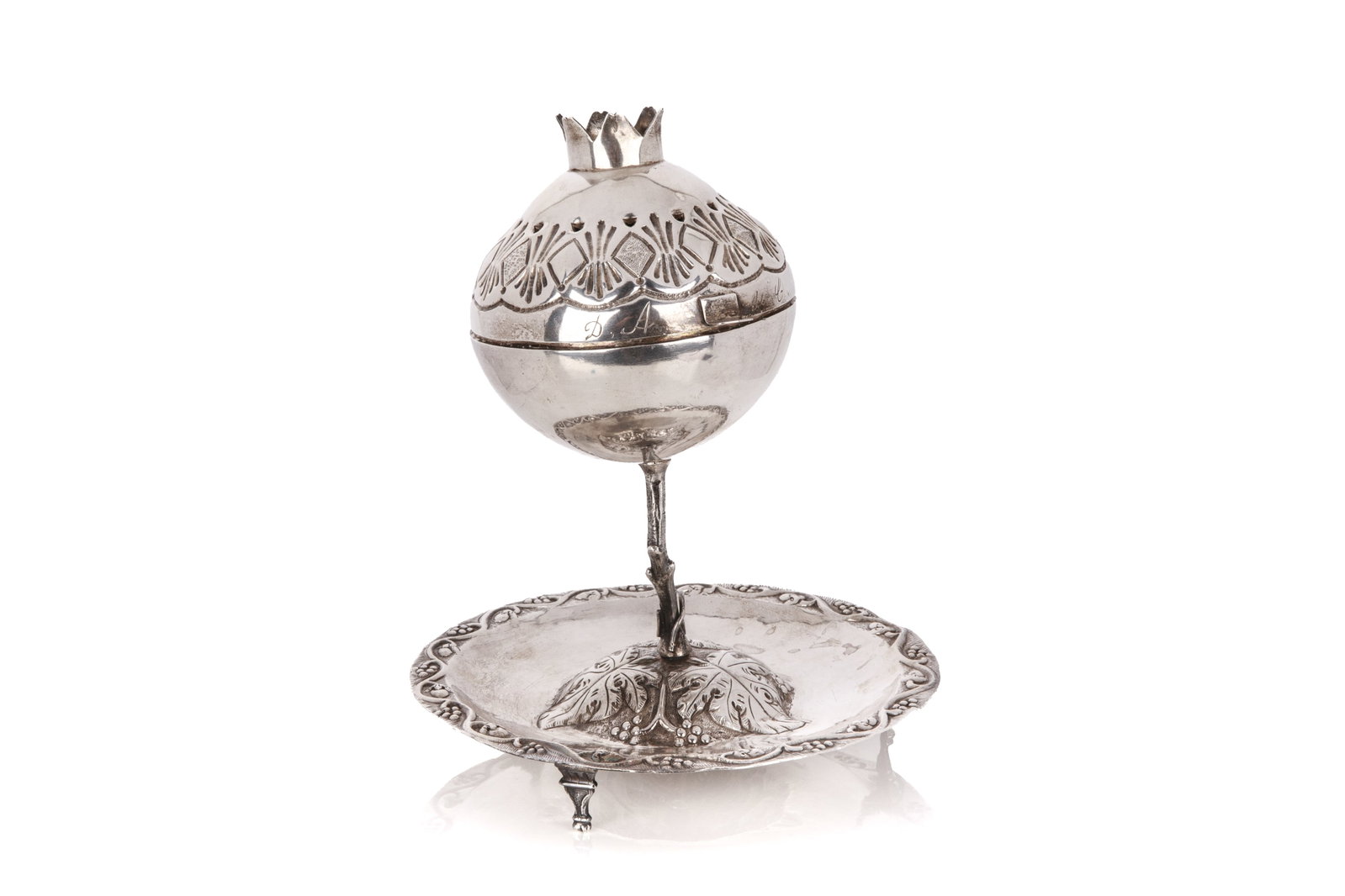 CONTINENTAL SILVER HAVDALAH SPICE TOWER, 321g: Shaped as a pomegranate spice container on a spreading base with grape and vine motif. The body engraved with family initials, Old test marks, hallmarks not identified, probably19th C. H 18cm (7in) W