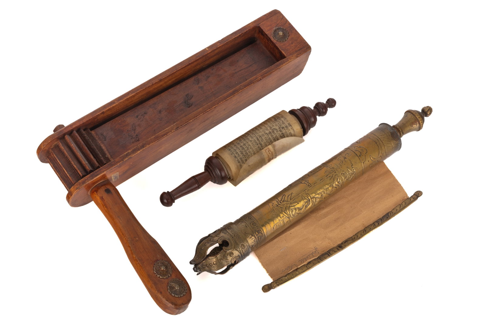 THREE PURIM RELATED JUDAICA ITEMS: A Scroll of the Book of Esther on old vellum, brass scroll case for Purim and a wood greggor with Hebrew text. H 10in (25.5cm) x L 13in (33cm)
