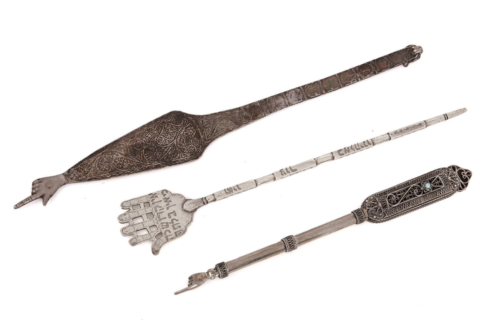 THREE YAD TORAH POINTERS: North African flat pointer, a hand with Hebrew text and a filigree silver pointer. L 11in (28cm)