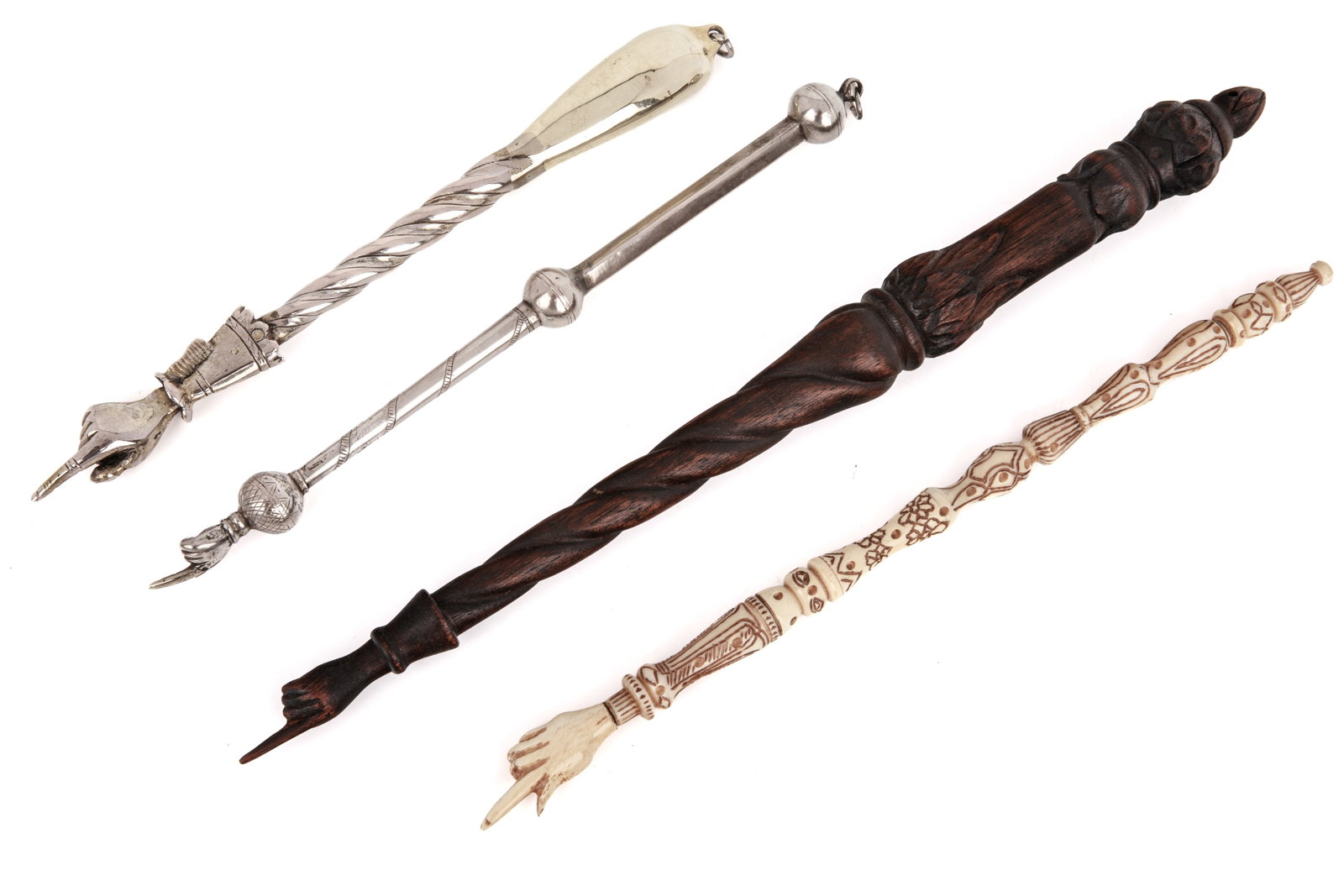 FOUR MIXED MATERIAL YAD TORAH POINTERS: In metal, silver, carved wood and bone. L 14 1/2in (37cm)