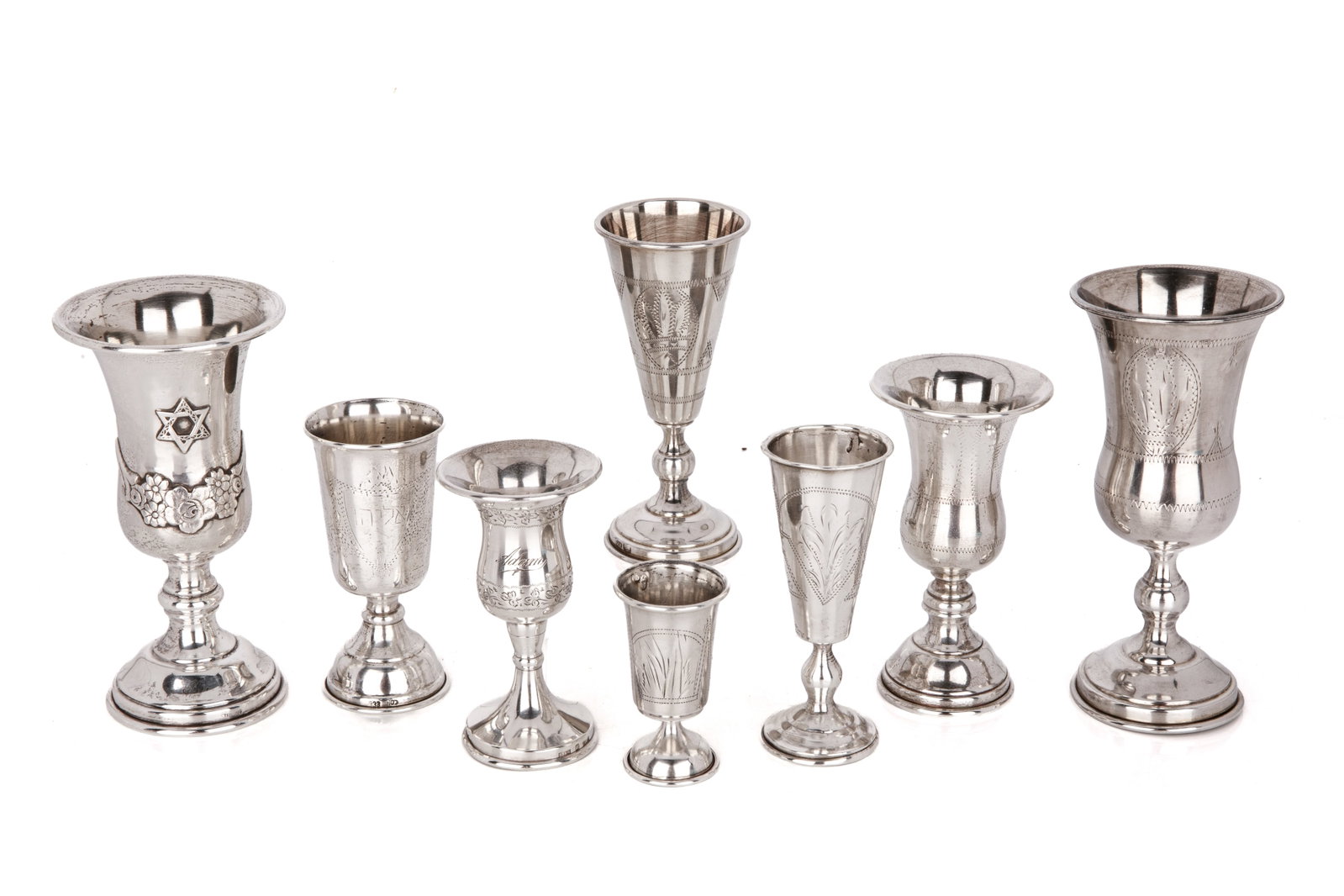 EIGHT SILVER KIDDUSH CUPS, 362g: Assorted sizes and origin including Israeli, Russian and American with etched decoration. H of tallest 362g total weightH 5in (13cm) x Dia 2 1/2in (6.5cm)