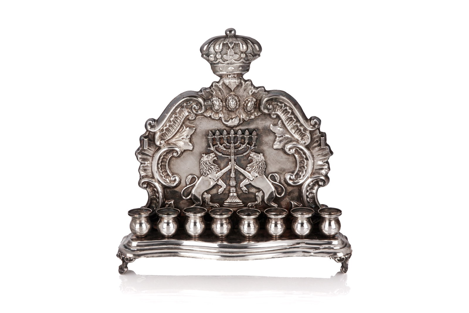 ANTIQUE POLISH SILVERPLATED HANUKAH MENORAH: Traditional form with eight lights, the shamash is missing, hallmarks for Warsaw, Poland. H 24cm (9 1/2in)