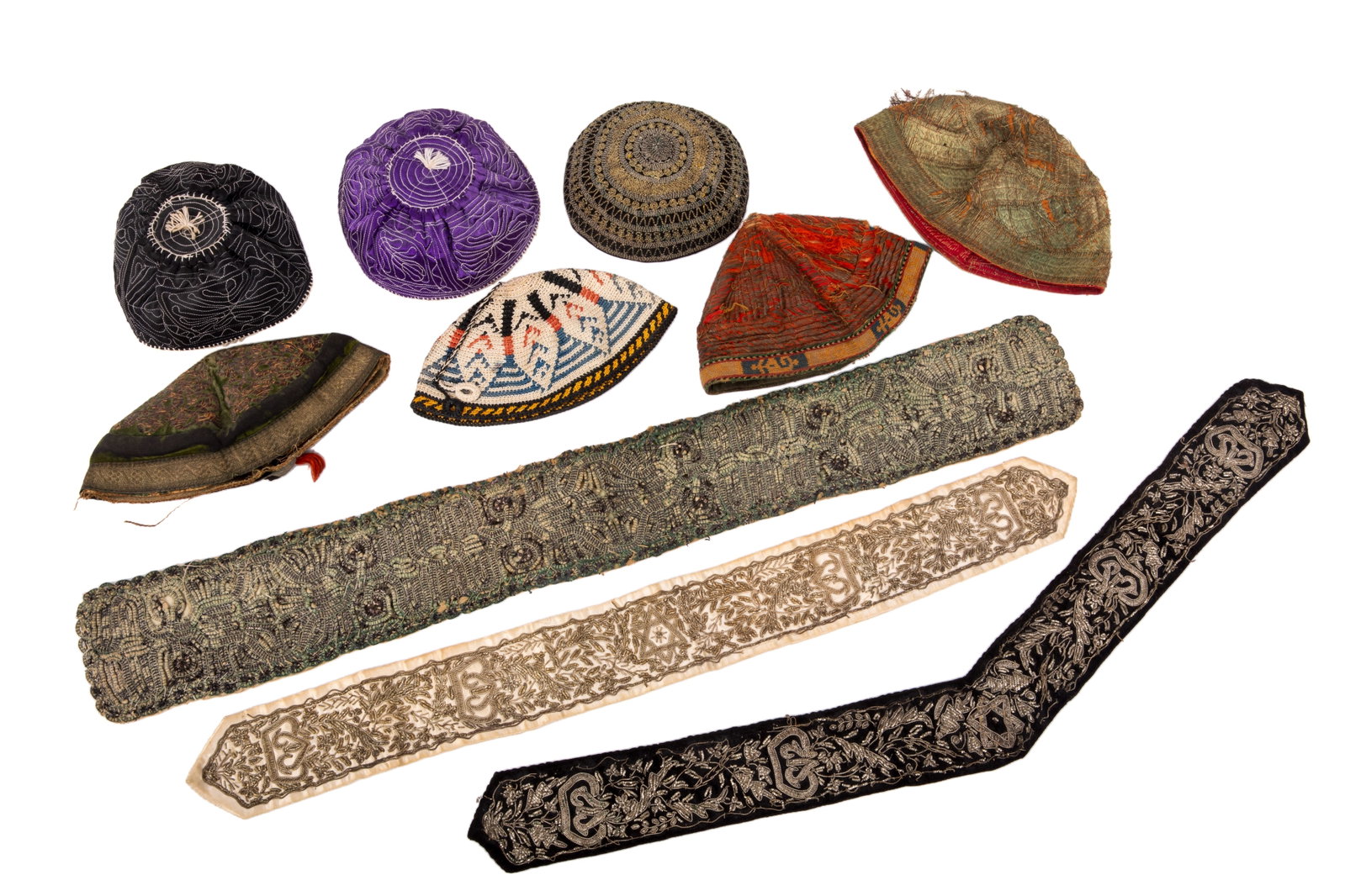 GROUP OF JUDAICA TEXTILES: Three embroidered accessories for the Tallit and seven embroised and metalic threaded head covers / Kippas.