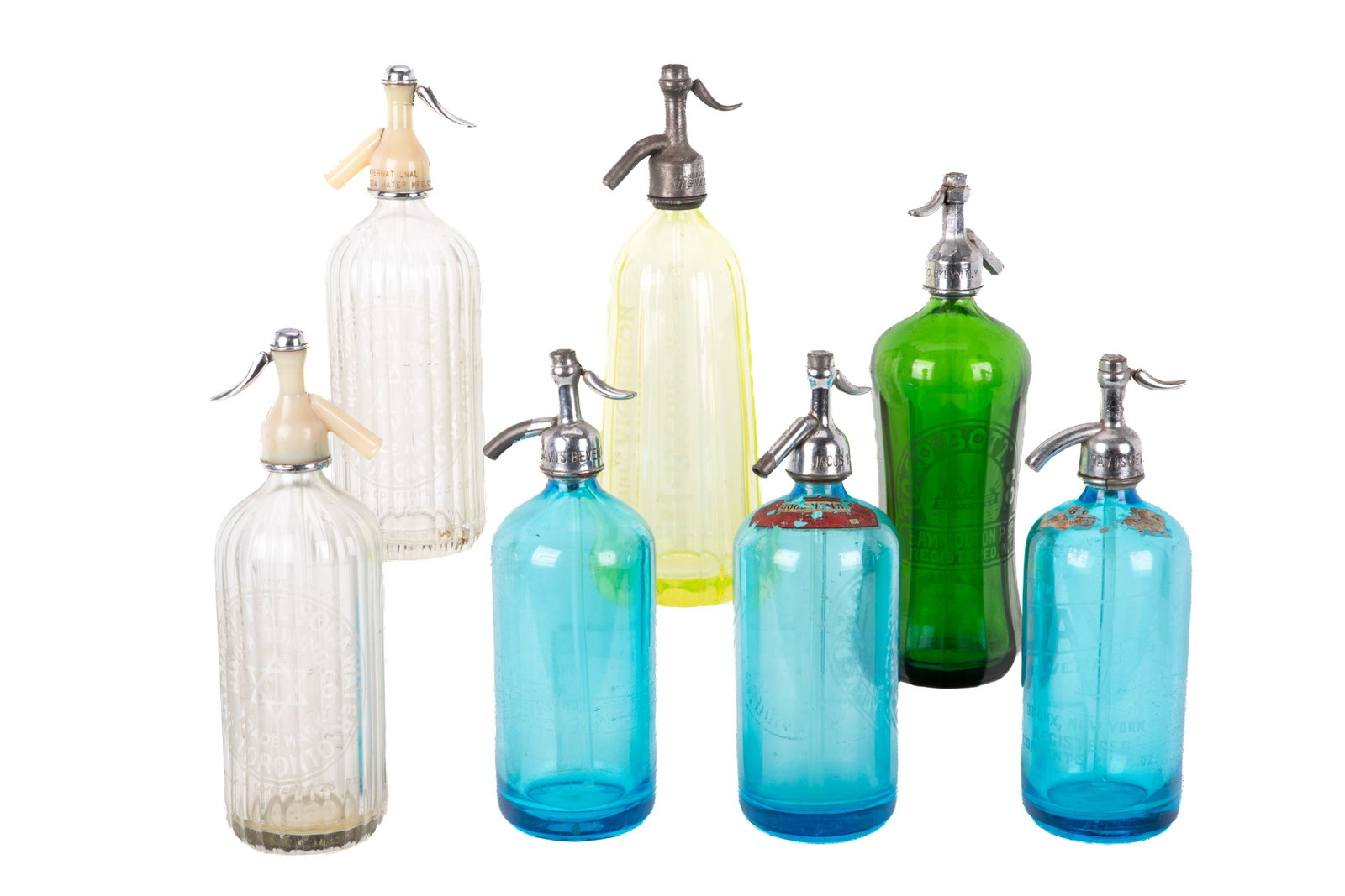 SEVEN VINTAGE GLASS SIPHON BOTTLES: Primarily American and French made with etched makers, two with Start of David. Including three blue, one green, one Vaseline and two clear glass.H of vaseline 33cm (13in)