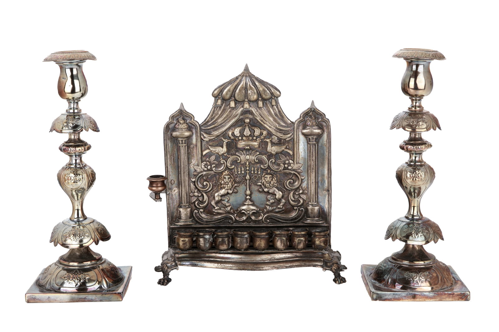 POLISH SILVERPLATED HANUKKAH LAMP & CANDLESTICKS: Menorah with lion and shield back (areas of restoration and repair) and two candlesticks by Fraget. H of sticks 32cm (10 1/2in)