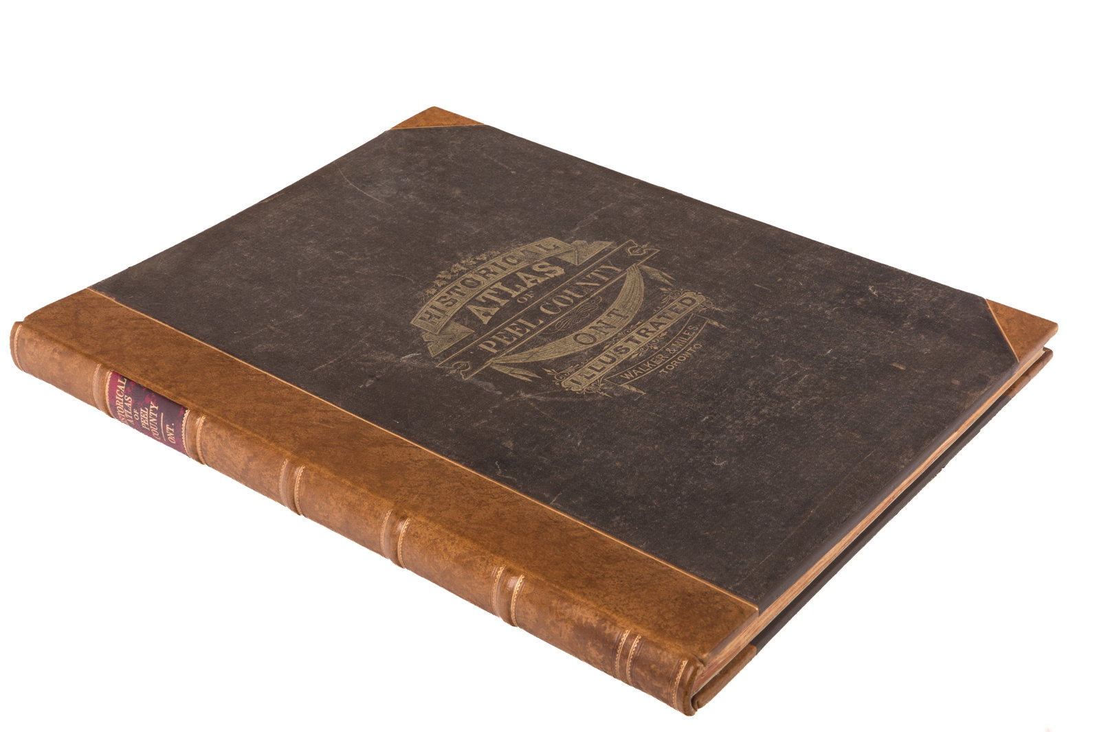 ILLUSTRATED HISTORICAL ATLAS OF THE COUNTY OF PEEL: Compiled and drawn from official plans and special surveys by J. H. Pope. Esq. Published by Walker & Miles, Toronto, 1877. Rebound quarter leather, decorative gilt title tofront boards. Folio.