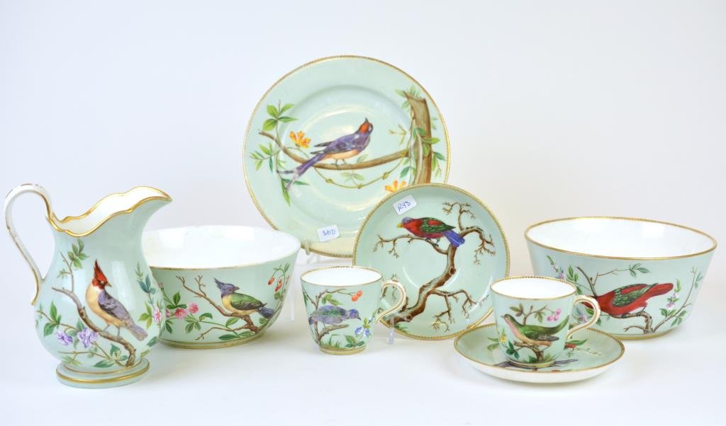 Minton 19th Cen Ornithological Porcelain Teawares: Green ground with hand painted birds, including two cups and saucers, a plate, two waste bowls and milk jug, dated 1871.