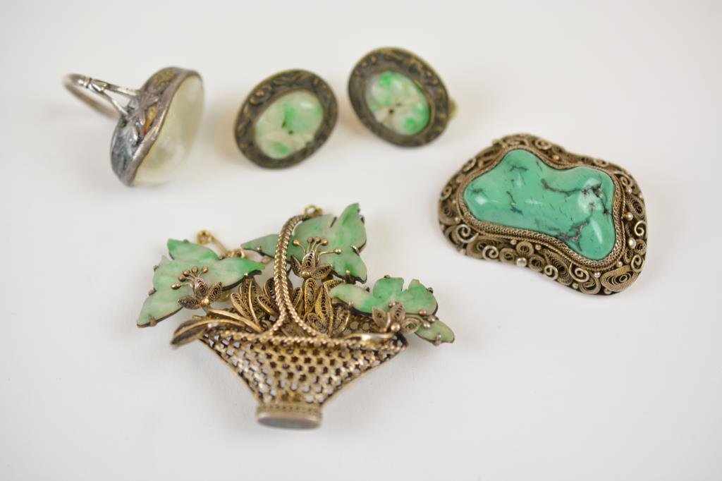 Lot of Chinese Silver Jewellery: Including a vermeil basket brooch with jadeite leaves, pair of earrings with jadeite plaques, brooch with malachite stone and a ring with abalone.
