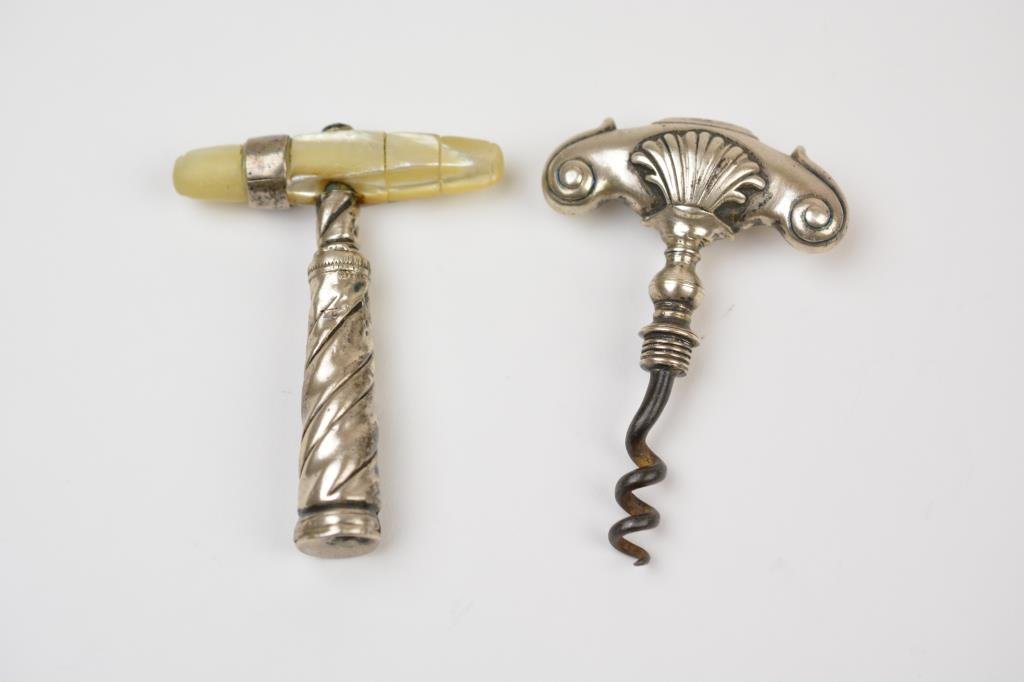Two Dutch Silver Corkscrews: The first with a mother of pearl handle and original cover, the second, with a shell capped silver handle, both probably 18th century.