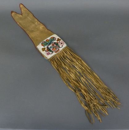 Native American beaded pipe bag: - possibly Northern Cree. Floral beadwork on hide body. Minor bead loss. Overall length including fringe is 34 in. Width: 6 1/8 in.