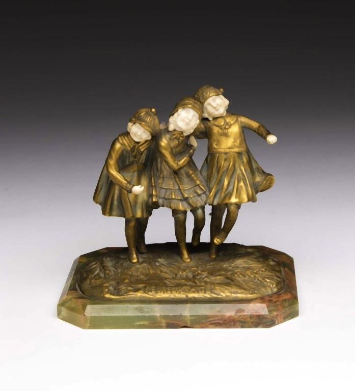 DEMETRE CHIPARUS: Romanian-French 1886-1947. Heureux Age, model no 5225. Of three girls in ormolu dresses, carved ivory faces and hands. Mounted to a green onyx base. H of bronze 18 cm (7 1/8 in.)