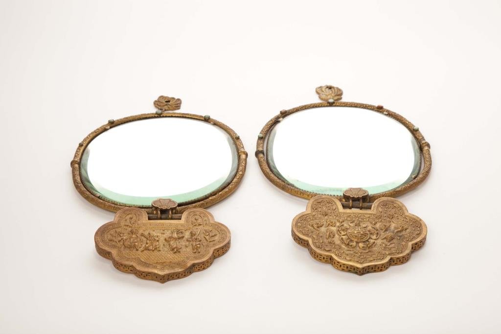 PAIR OF SMALL 19th CEN CHINESE HAND MIRRORS: Gilt frame hammered with floral ornaments inserted with semi-precious stones, suspending to a ruyi-head pendant,with figural decorations and auspicious wishes to both sides. L. 33cm (13 in.)