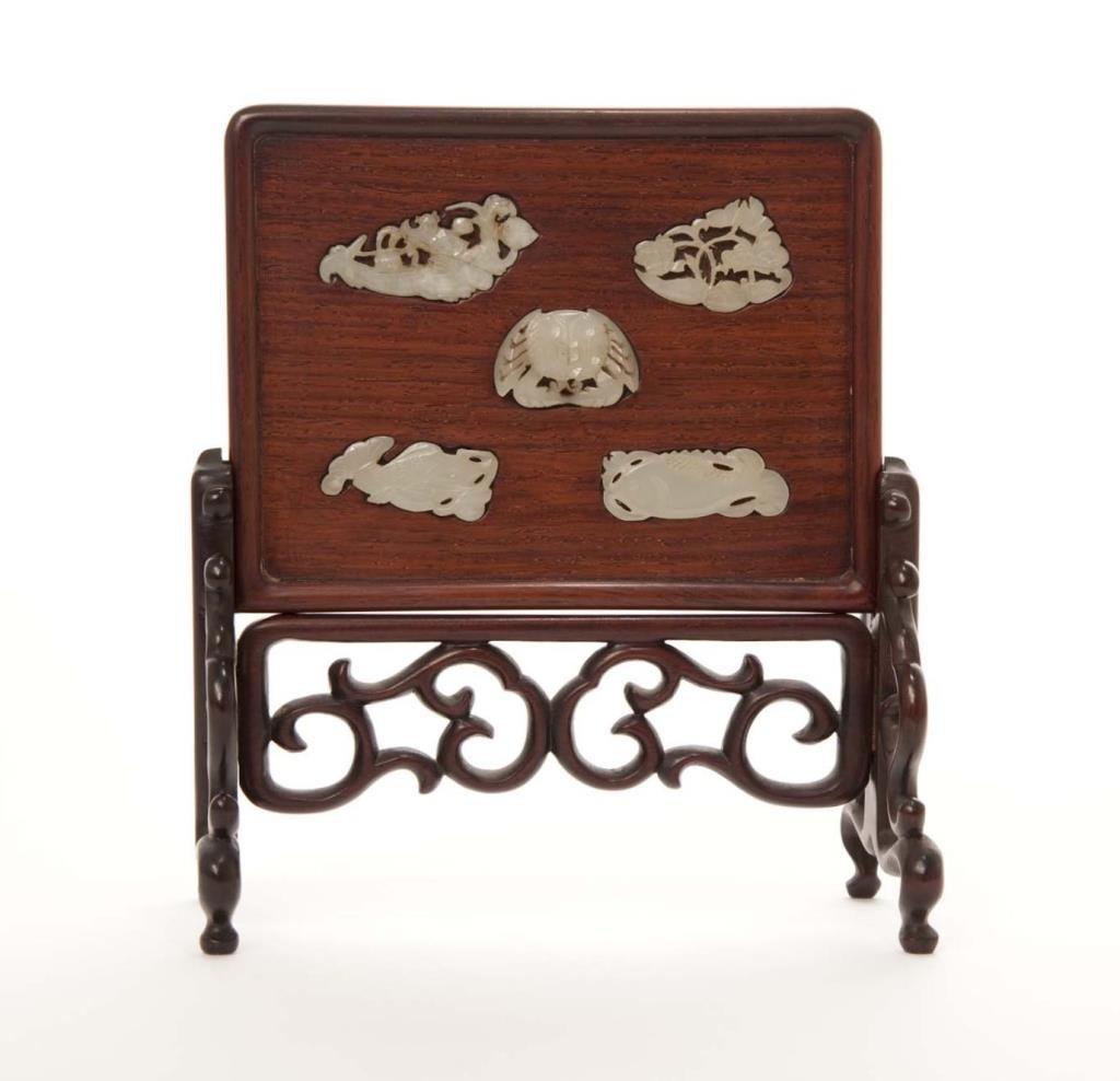 CHINESE JADE AND HARDWOOD TABLE SCREEN: Rectangular form panel inserted with celadon jade carvings of fish, crab, and lotus root. Longest jade 5 cm (2 in.), H. of screen 19.7cm (7 3/4 in.)