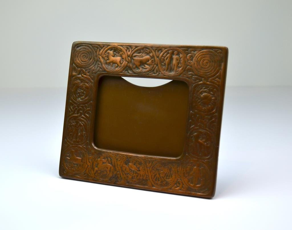 Tiffany Studios New York Bronze Zodiac Frame: Pattern 943. W 21 cm. (8 1/4 in.) No glass in the frame