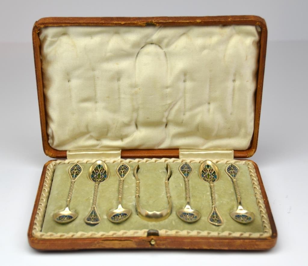 Cased Set of Norwegian Silver Plique A Jour Spoons: Six gilt silver spoons and sugar nips with polychrome enamel, David Anderson, in a fitted leather case. L of spoon 11.5 cm. (4 1/2 in.) One spoon with minor loss
