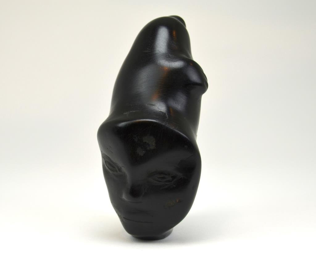 Unidentified Inuit Artist: Human & Seal Spirit Black soapstone; signed in Syllabic 5 1/2 in.