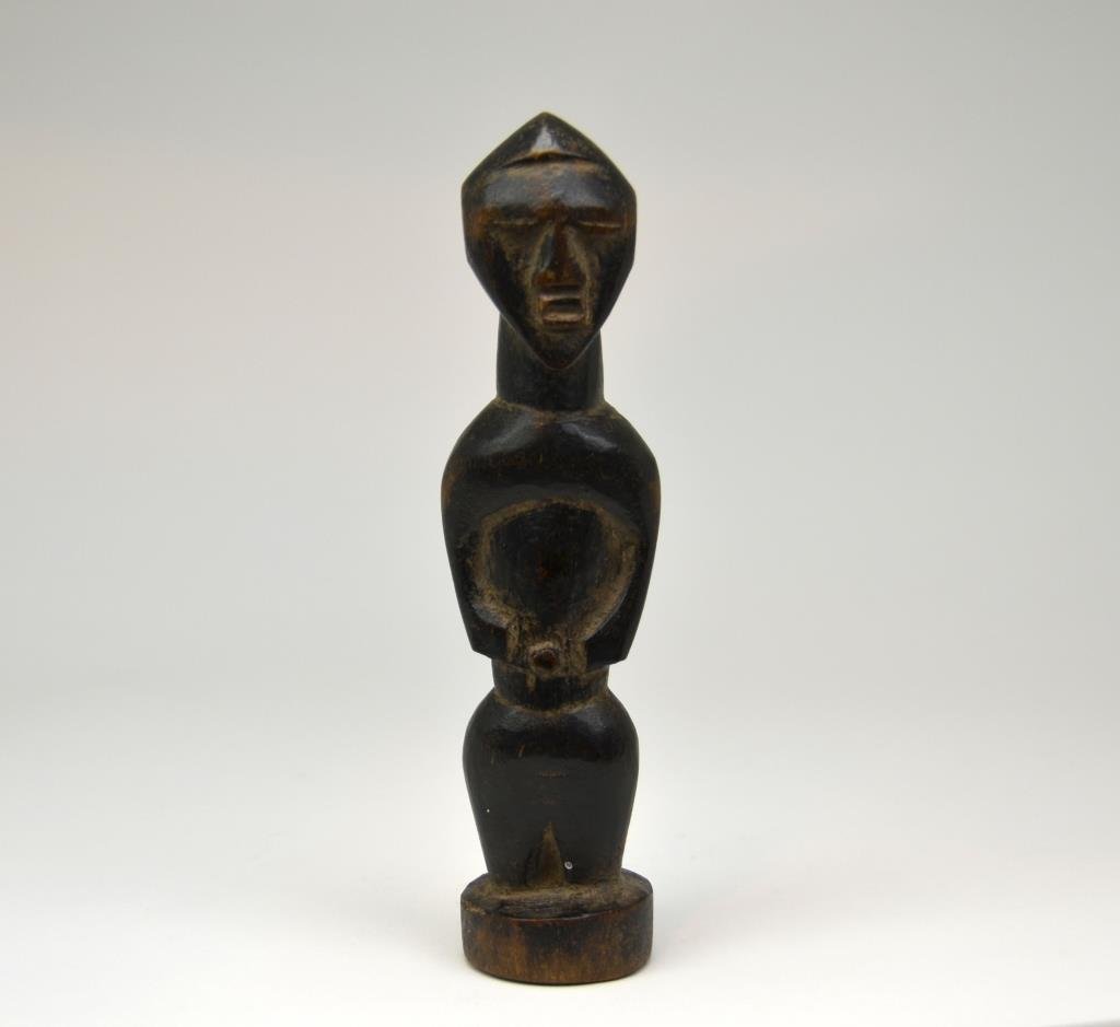 Small African Carved Wood Figure: Standing man with belly button, good patination. H 7 1/2 in.