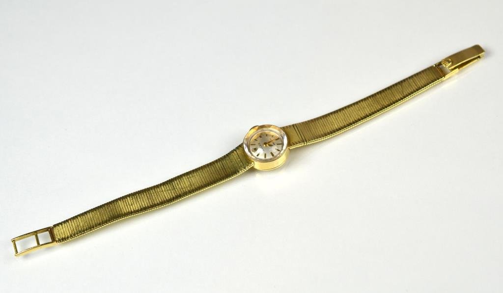 LADY'S YELLOW GOLD ROLEX WRIST WATCH: 14k gold Precision dial with a flat band baring French hallmarks and Rolex crown, 21g.
