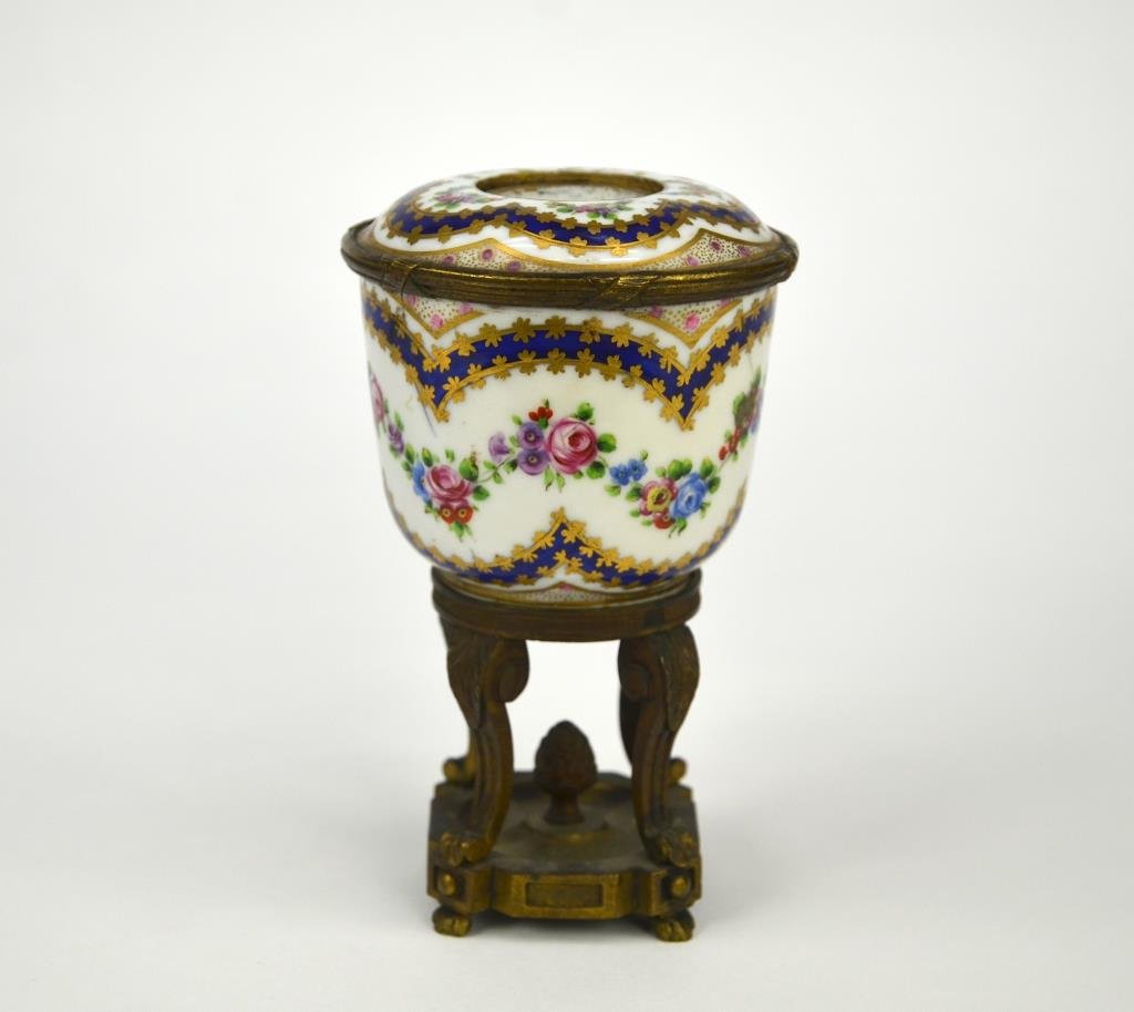 FRENCH PORCELAIN INKWELL ON BRONZE STAND: Painted with floral sprays, Sevres mark to base H. 14.5 cm (5 3/4 in.) cracked