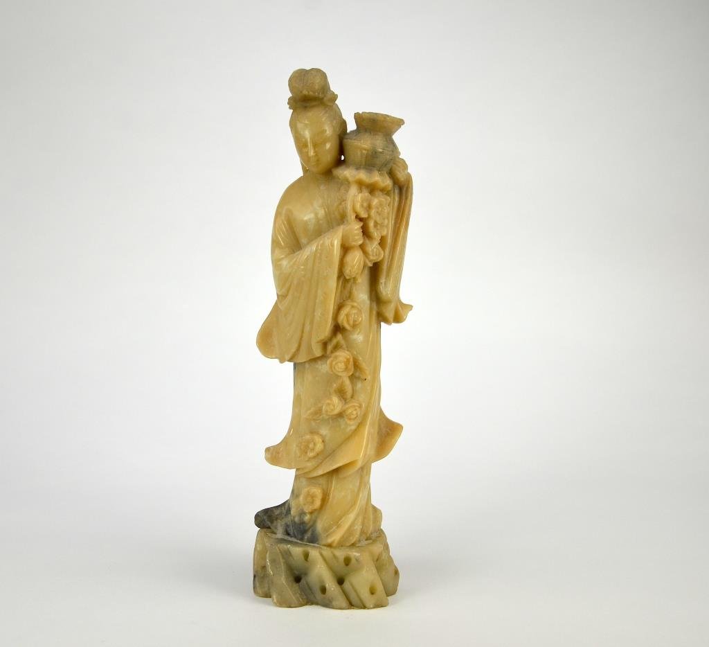 CHINESE CARVED SOAPSTONE FIGURE OF GODDESS: Her one hand holds a branch of flower and the other a woven basket. H. 34.2cm (13.5 in.) No chip
