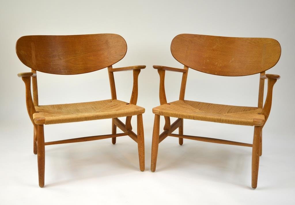 HANS WEGNER TEAK LOUNGE CHAIRS: With shell back and rush seat, impressed FH67 and original label for Carl Hansen & Son Mobelfabrik, mid 20th c. H. 71 cm (28 in.)