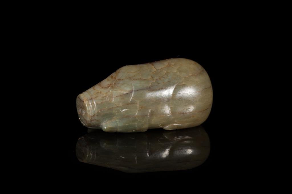 GREEN ROUNDED JADE PIG: Mottled veining, fully cut in the round with defined body and snout, possibly Song or Han Dynasty. L 6.4 cm. (2 1/2 in.) From the Irving Langleb collection, a prominent Jewish gentleman who resided in
