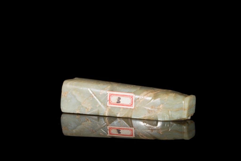 GREEN JADE 8-CUT BURIAL PIG: Light mottled jade, well cut on two sides with a flat base, Han Dynasty. L 9.5 cm. (3 3/4 in.) From the Irving Langleb collection, a prominent Jewish gentleman who resided in Japan post-WWII and was a