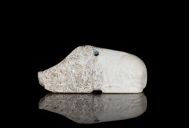 CALCIFIED GREEN JADE BOAR PENDANT: With finely carved details in the face, ribs and behind. Drilled hole in the top for the use of a pendant, Song Dynasty. W 6.5 cm. (2 1/2 in.) From the Irving Langleb collection, a prominent Jewish ge