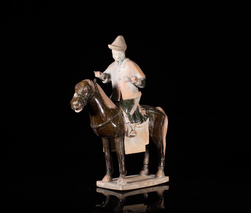 MING DYNASTY POTTERY EQUESTRIAN FIGURE: Dressed in official's uniform, partially dark green and dark brown glaze, on raised rectangular base. H. 36cm (14 1/8 in.)